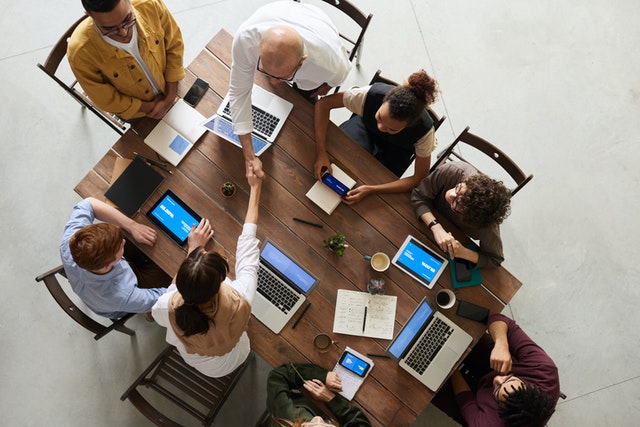 Team of people working around a dinner table