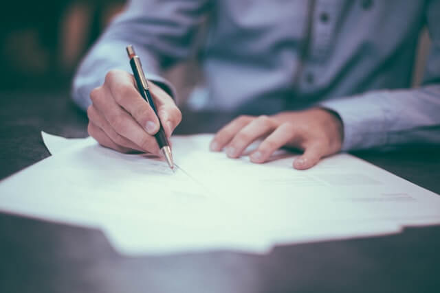 Man writing a business/legal document