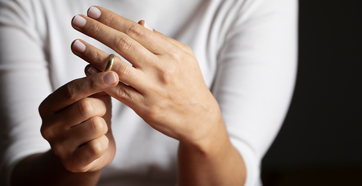 A woman taking of her wedding ring