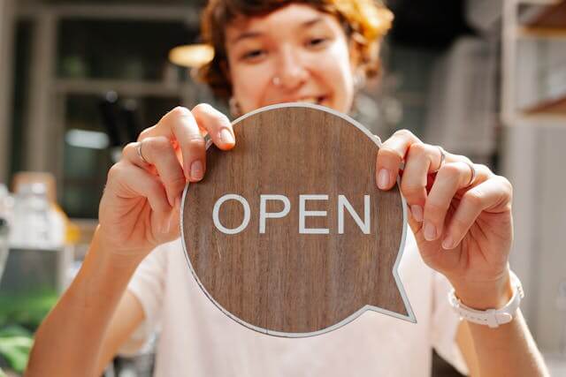 Women holding an Open sign