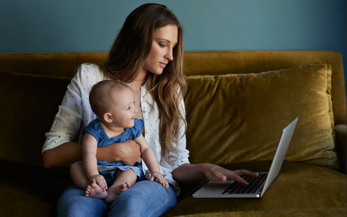 women holding a baby while working