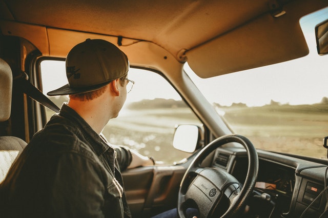 Man Wearing Black Denim Jacket in Driver's Seat