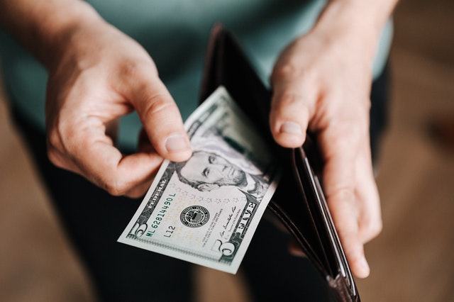 man holding wallet with money