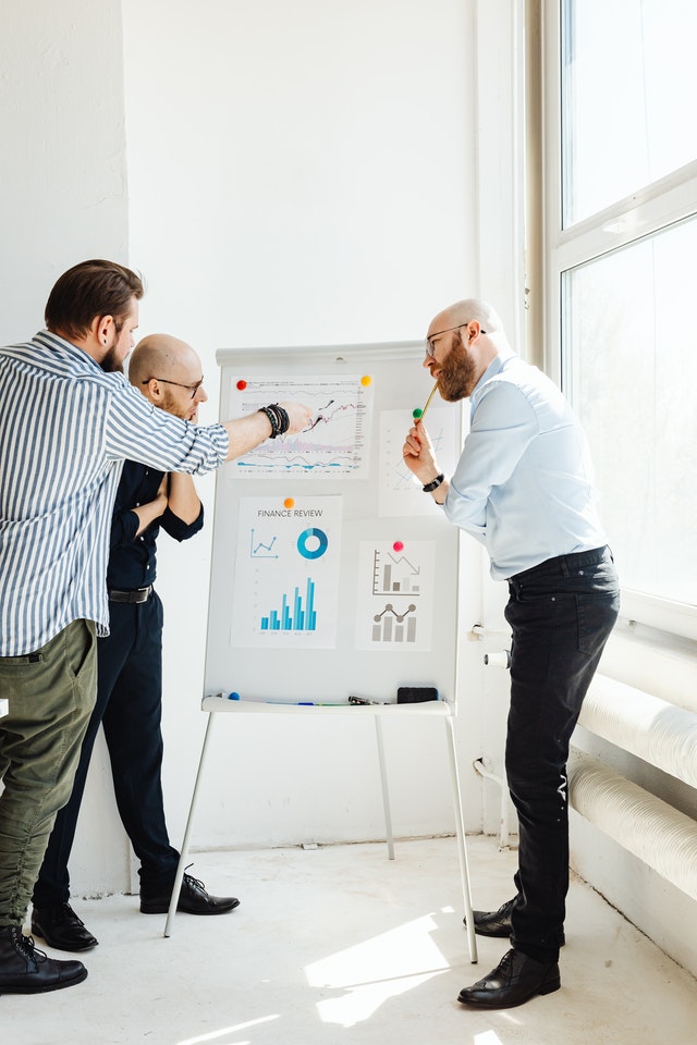 Business people in front of a white board