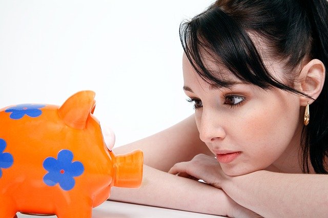 Women looking at piggy bank