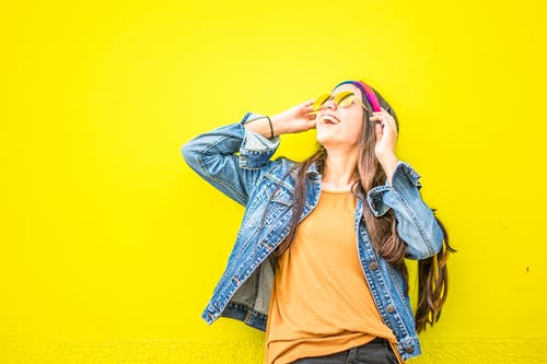 Young woman with bold yellow backgrounds