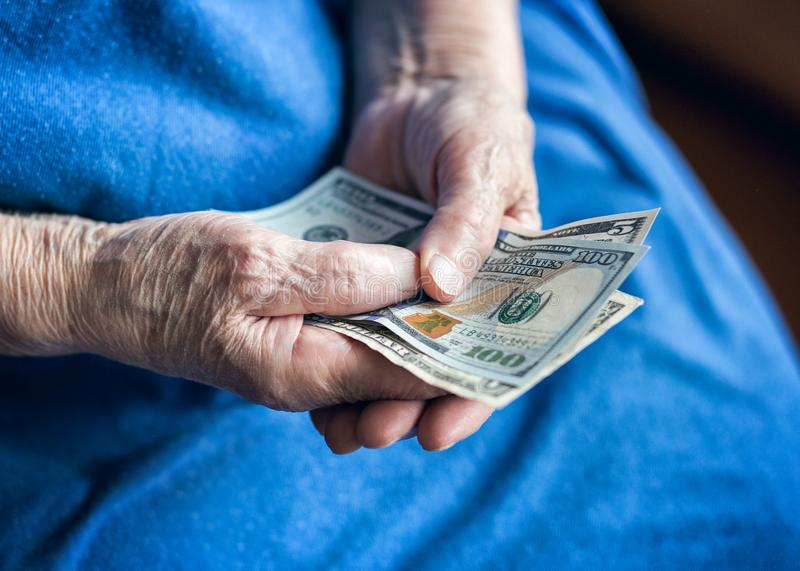 Elder man holding money