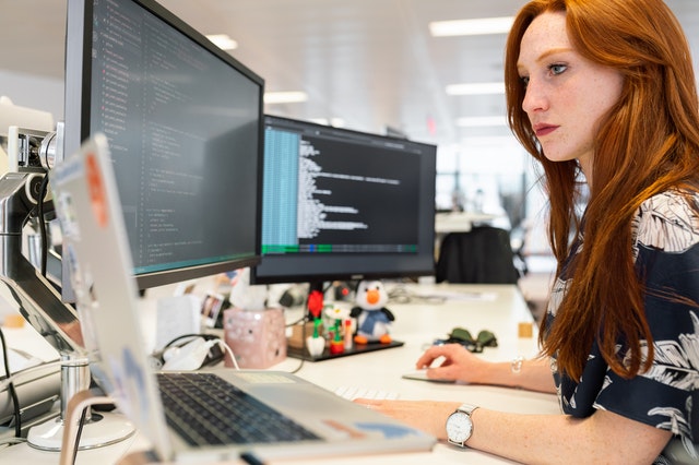 Women working with two computer screens