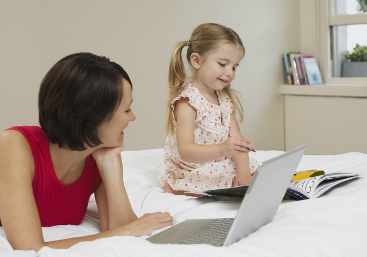 Business woman with little girl, working