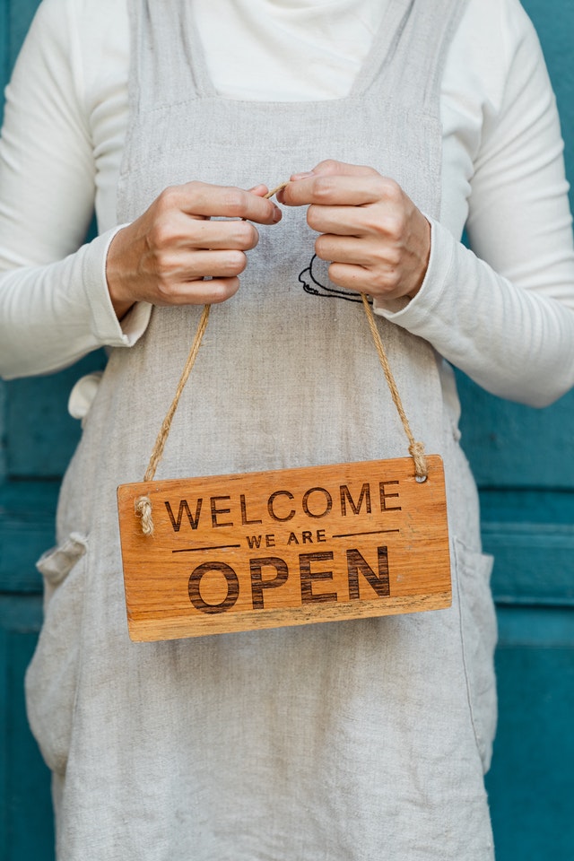 woman with an open sign