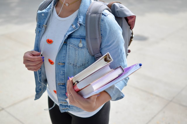 Collwge student holding books