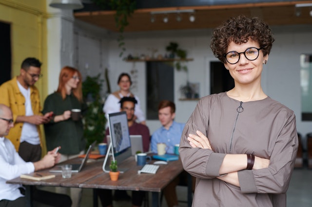 Women in the foreground and office workers on the background