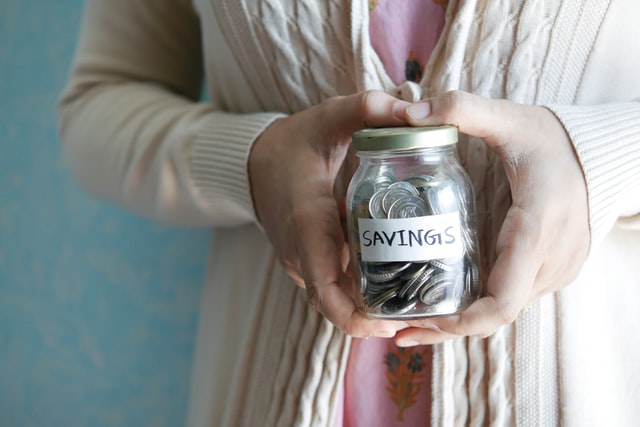 Woman holding savings jar