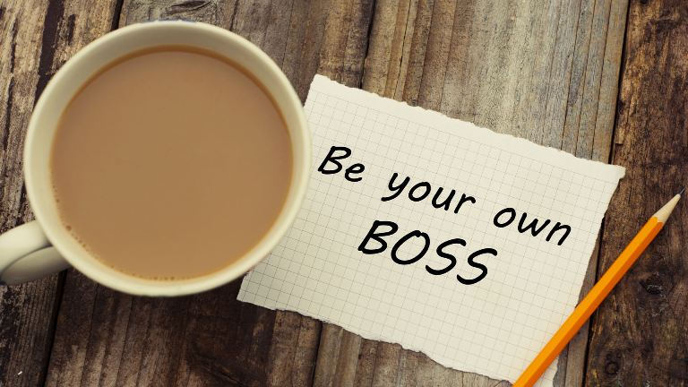 Be your own boss message next to a coffee cup