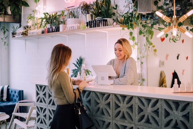 custormer at the cashier's desk paying for something