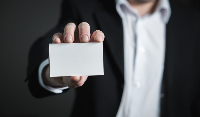 Man holding a blank business card