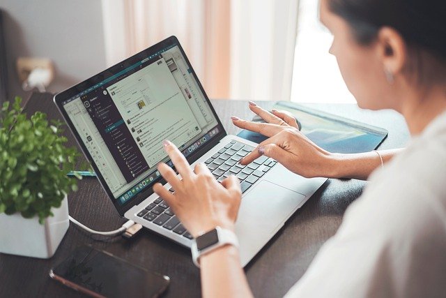 Women typing on a laptop computer