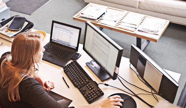 Automation At Work, women in front of two computer screense