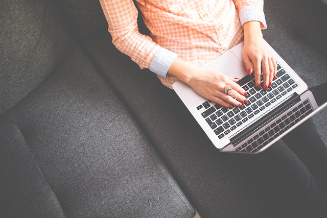 Woman writing on a laptop computer