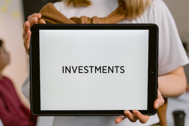 The word "Investments" written on a tablet