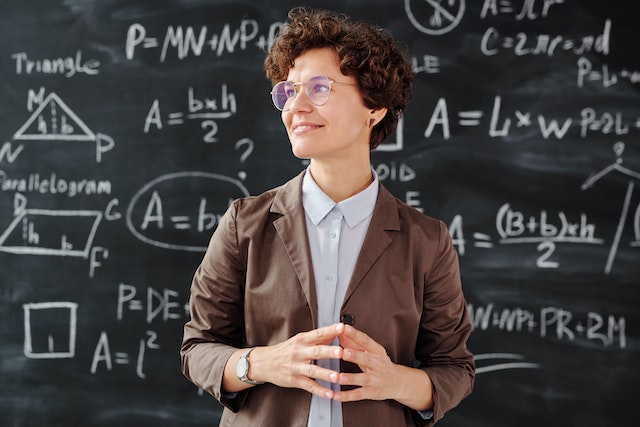 Female teacher in Brown Blazer Wearing glasses