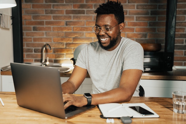 Black man typing on his laptop