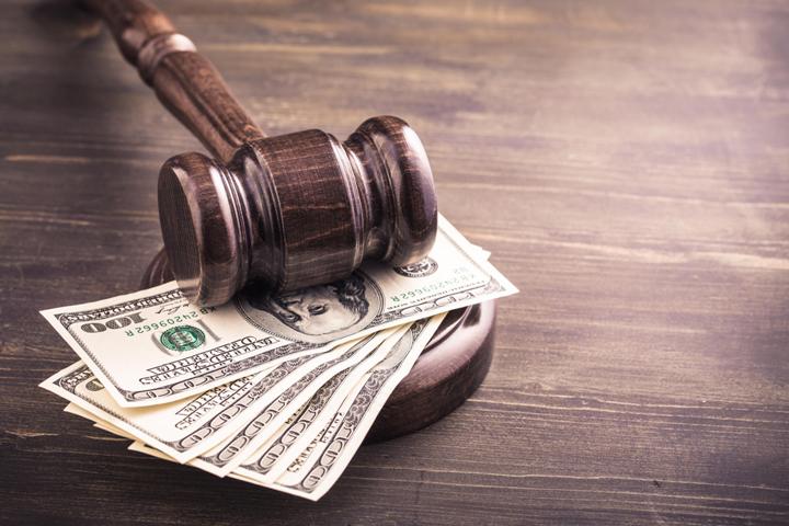 Compensation Law; Gavel and dollars banknotes on table