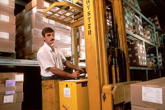 Man operating a forklift at a warehouse