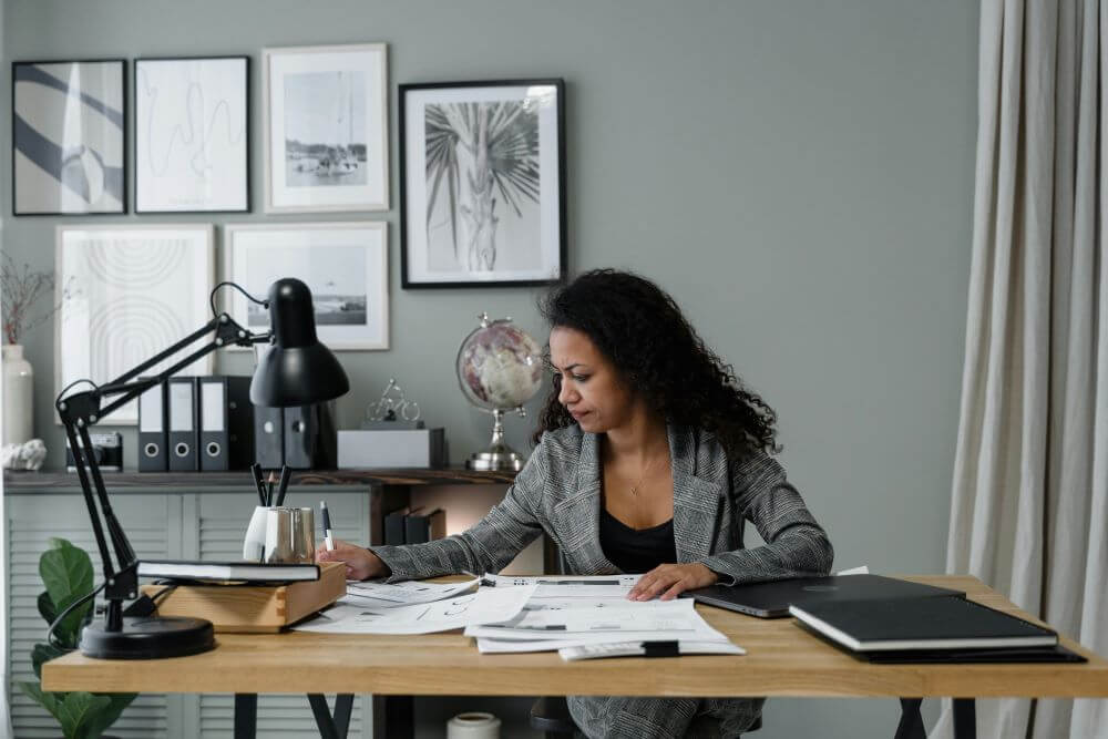 Black women working with financial papers