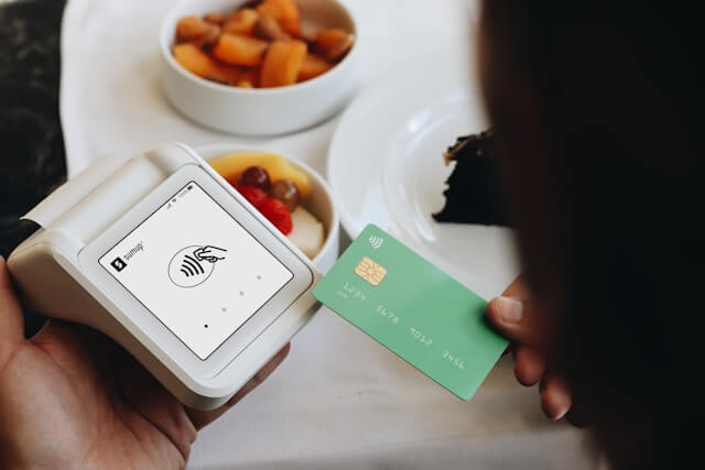 A person paying with a credit card at a restaurant