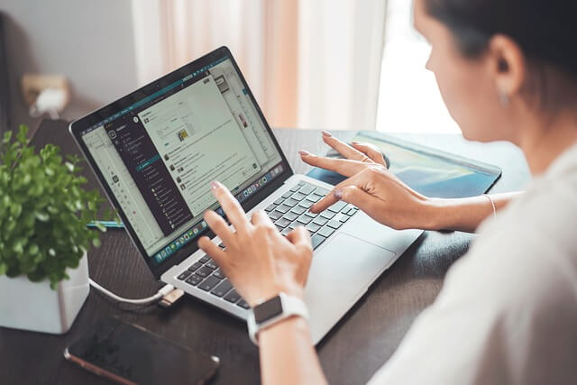 Woman typing on a laptop